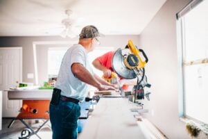 men working with tools inside a house